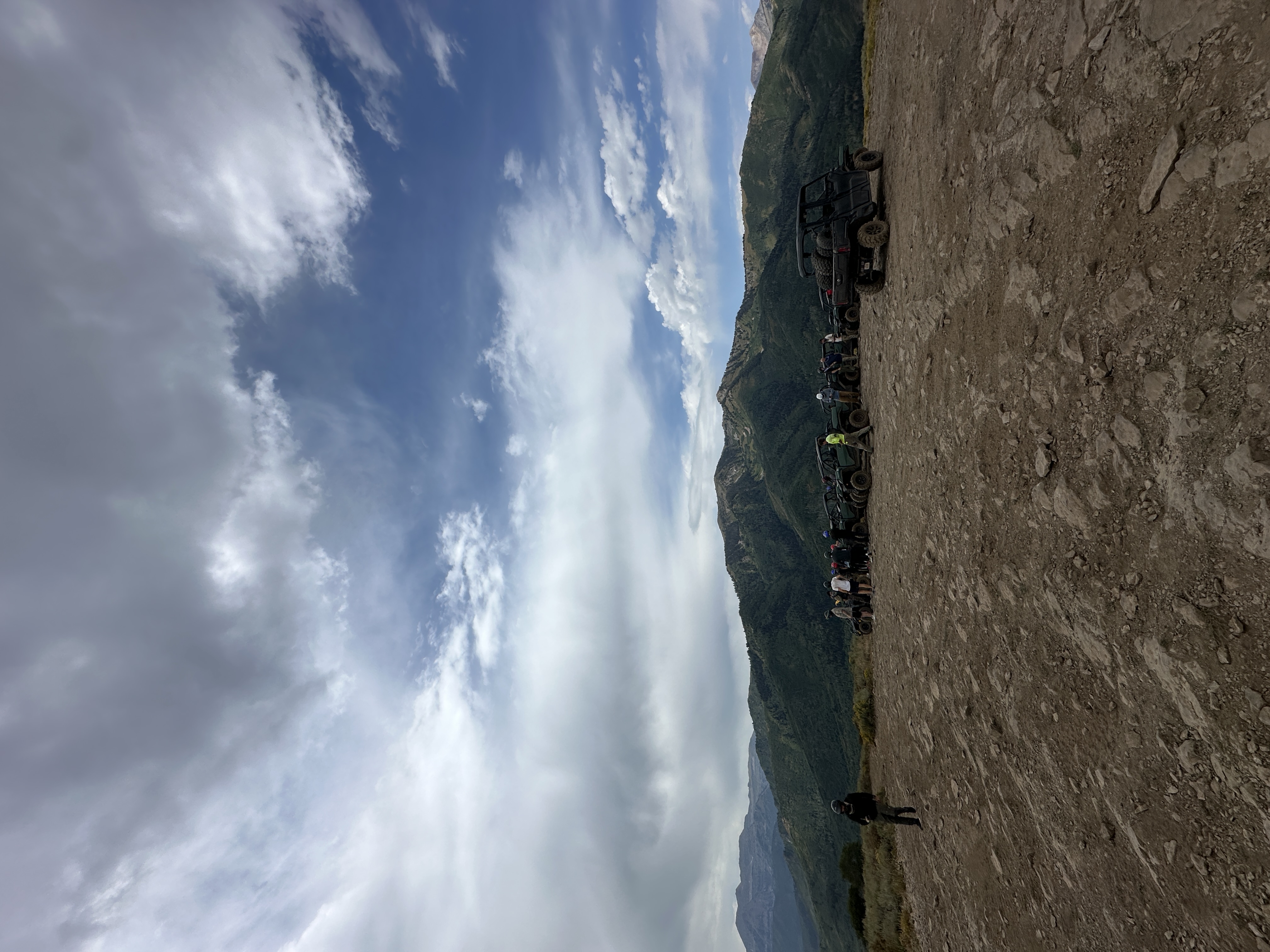 Outdoor mountain adventure event with ATVs and scenic mountain backdrop