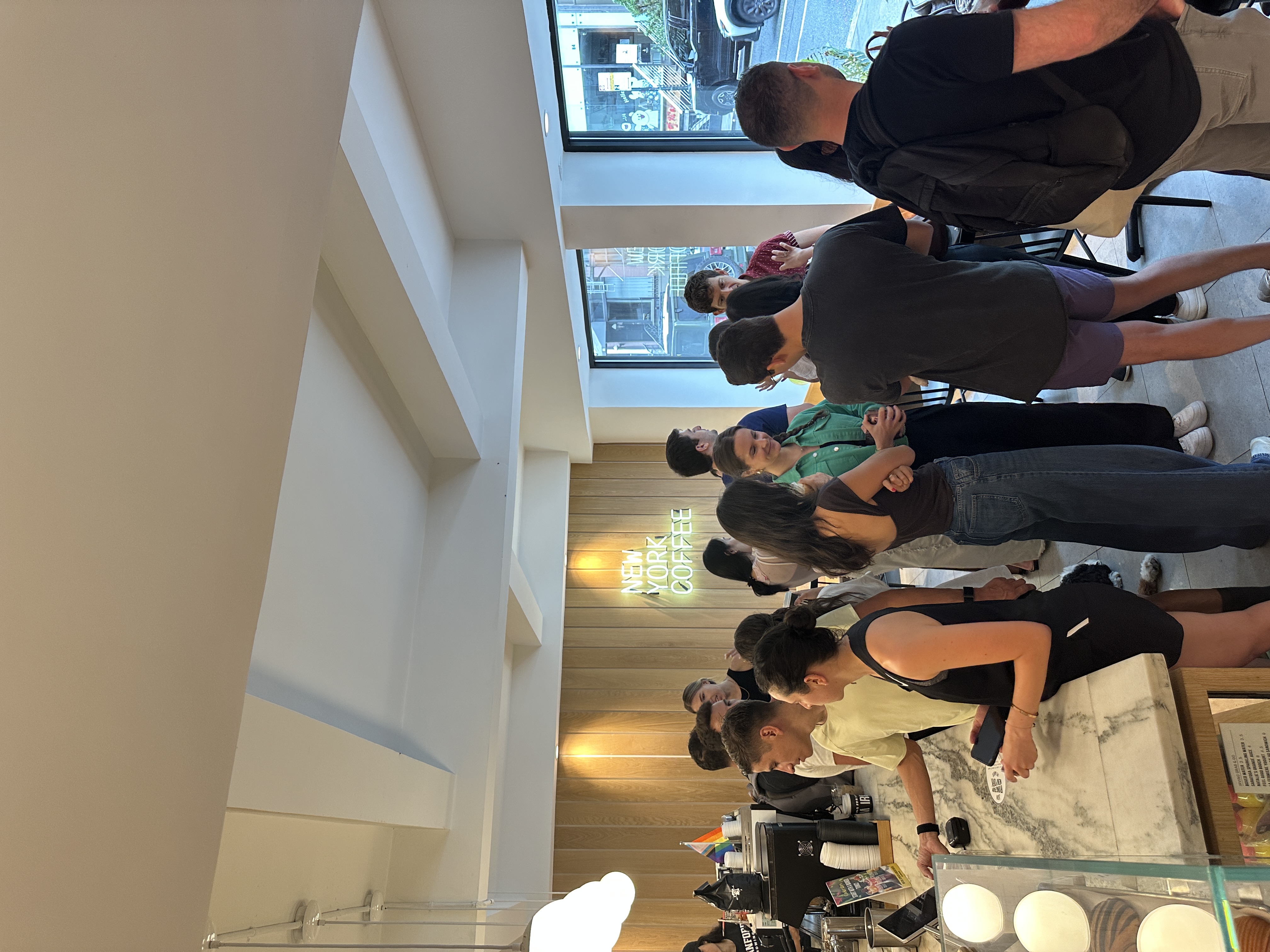 Networking event at New York Coffee with modern interior and neon signage