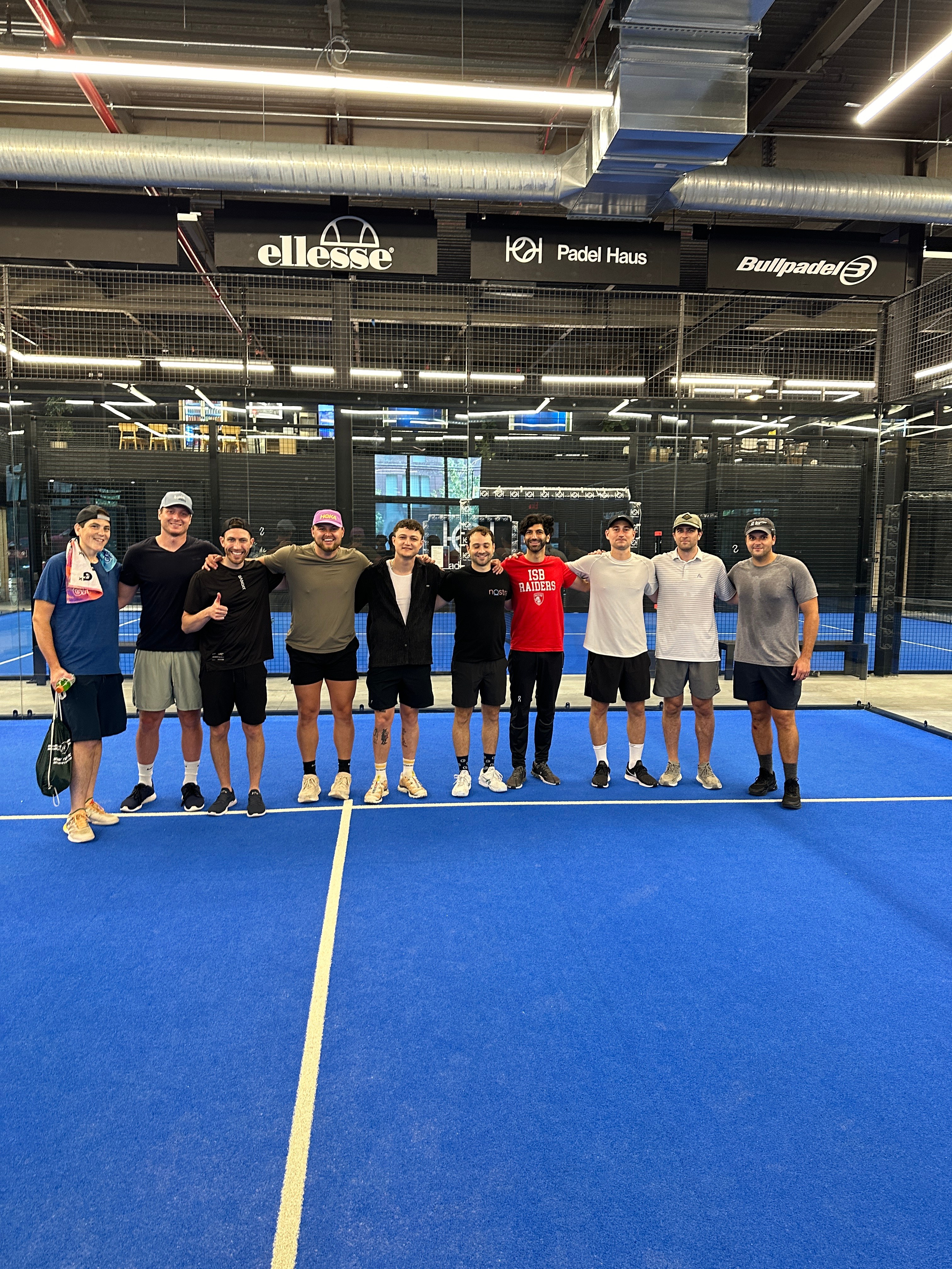 Group photo on padel tennis court at recreational sports event